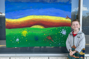  Student poses in front of his artwork